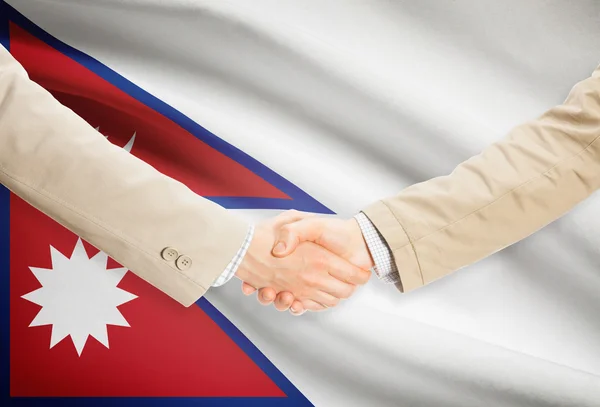 Businessmen handshake with flag on background - Nepal — Stock Photo, Image