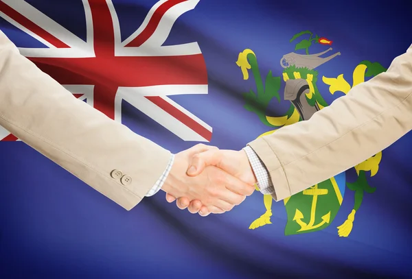 Businessmen handshake with flag on background - Pitcairn Island — Stock Photo, Image