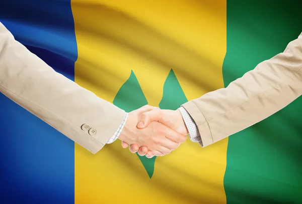 Businessmen handshake with flag on background - Saint Vincent and the Grenadines — Stock Photo, Image