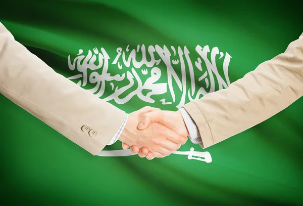 Businessmen handshake with flag on background - Saudi Arabia — Stock Photo, Image