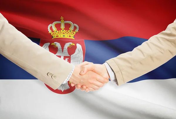 Businessmen handshake with flag on background - Serbia — Stock Photo, Image