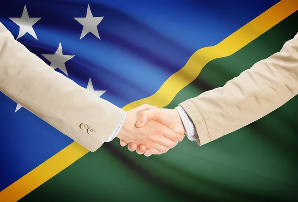 Businessmen handshake with flag on background - Solomon Islands — Stock Photo, Image