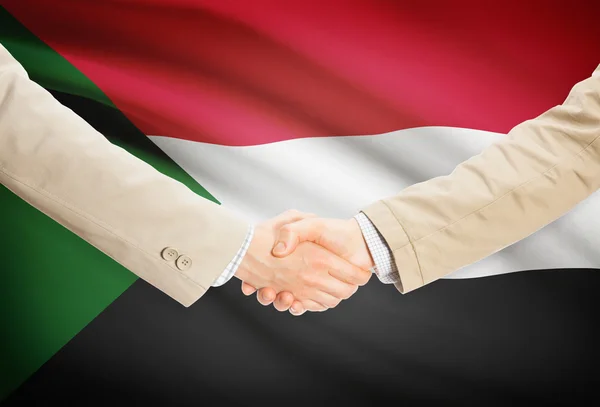 Stretta di mano degli uomini d'affari con la bandierina su priorità bassa - Sudan — Foto Stock