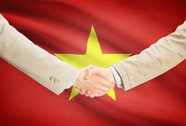 Businessmen handshake with flag on background - Vietnam — Stock Photo, Image