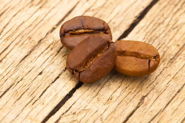 Coffee beans on old table - close up shot — Stock Photo, Image