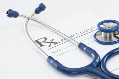 Stethoscope with medical drug prescription on table