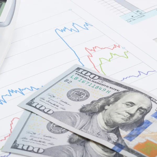 Stock market graph with calculator and 100 dollars banknote - close up — Stock Photo, Image