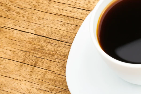 Cup of black coffee on neat table - close up studio shot — Stockfoto