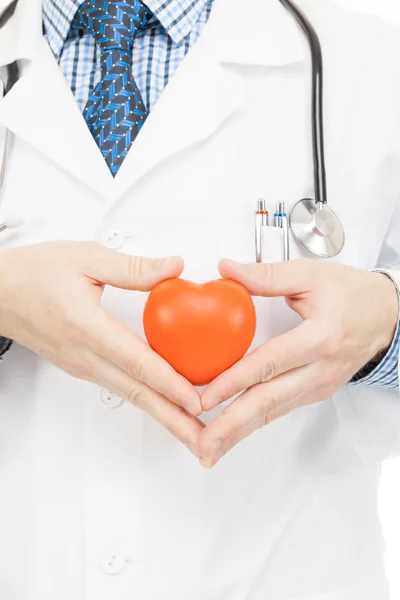 Doctor holding toy heart with two hands - health care concept — Stock Photo, Image