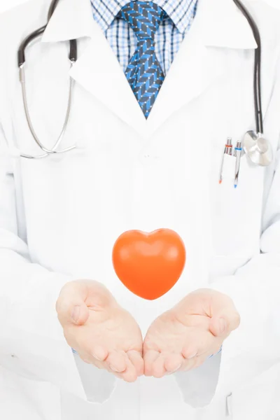 Toy heart floating in air over doctors palms - health care concept — Fotografia de Stock