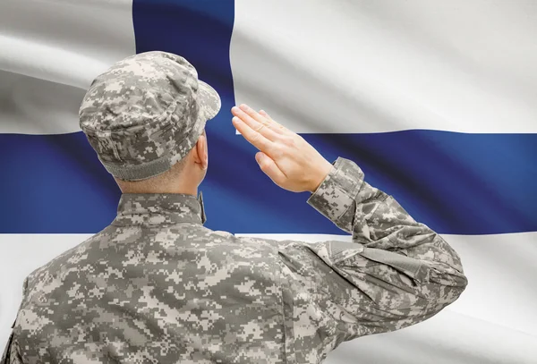 Soldier in hat facing national flag series - Finland — Stock Photo, Image