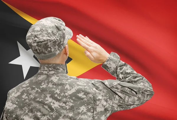 Солдат в шляпе, стоящие перед национальным флагом серии - Восточный Тимор — стоковое фото