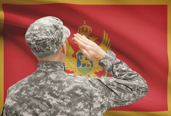 Soldier in hat facing national flag series - Montenegro — Stock Photo, Image