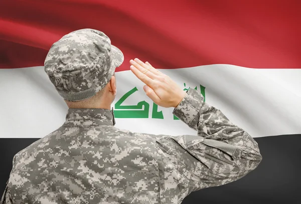 Soldier in hat facing national flag series - Iraq — Stock Photo, Image