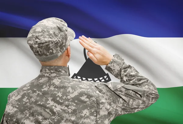 Soldier in hat facing national flag series - Lesotho — Stock Photo, Image