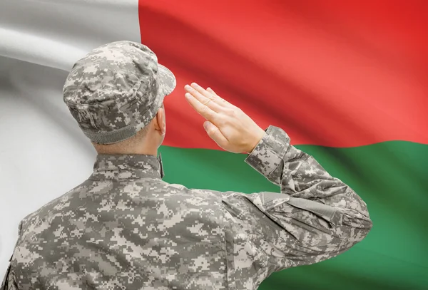 Soldier in hat facing national flag series - Madagascar — Stock Photo, Image