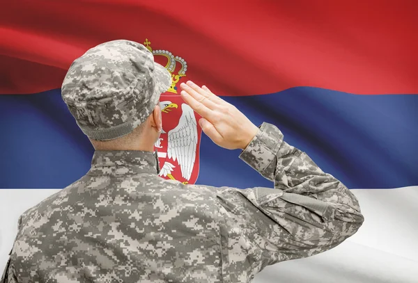 Soldier in hat facing national flag series - Serbia — Stock Photo, Image