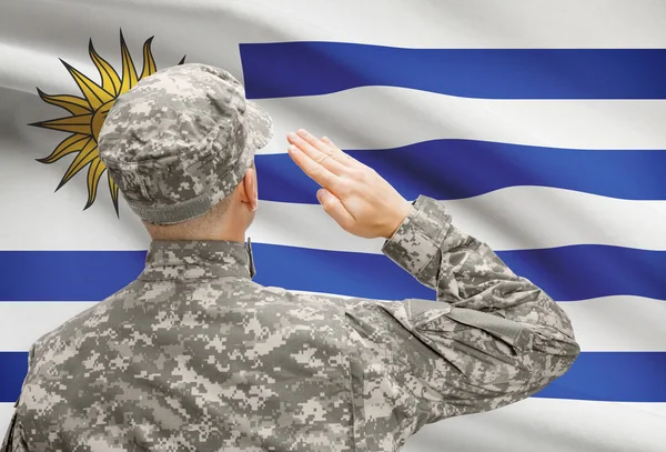 Soldier in hat facing national flag series - Uruguay — Stock Photo, Image