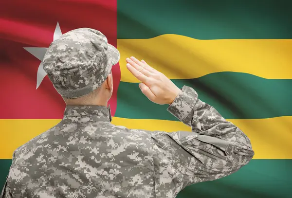 Soldier in hat facing national flag series - Togo — Stock Photo, Image