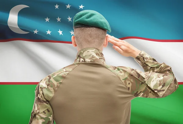 National military forces with flag on background conceptual series - Uzbekistan — Stock Photo, Image