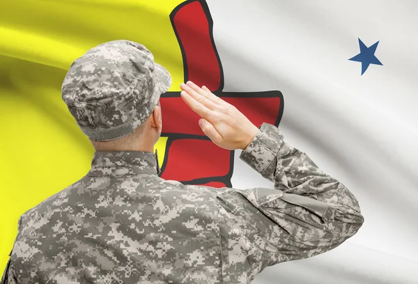 Soldier saluting to Canadial province flag series - Nunavut — Stock Photo, Image