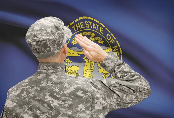 Soldier saluting to US state flag series - Nebraska — Stock Photo, Image