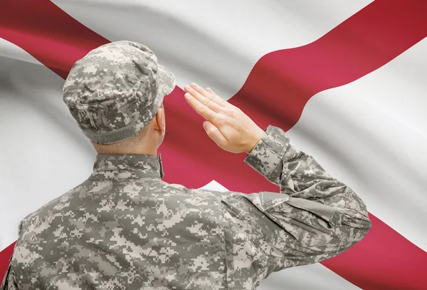 Soldier saluting to US state flag series - Alabama — Stock Photo, Image