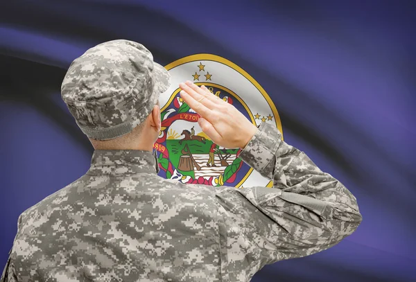 Soldier saluting to US state flag series - Minnesota — Stock Photo, Image