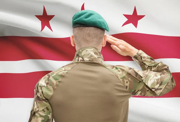 Soldier saluting to USA state flag conceptual series - District of Columbia — Stock Photo, Image