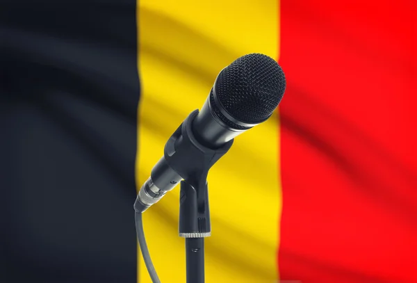 Microphone on stand with national flag on background - Belgium — Stock Photo, Image