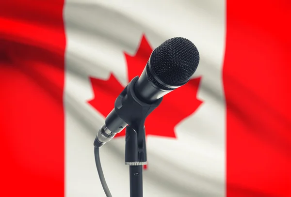 Microphone on stand with national flag on background - Canada — Stock Photo, Image