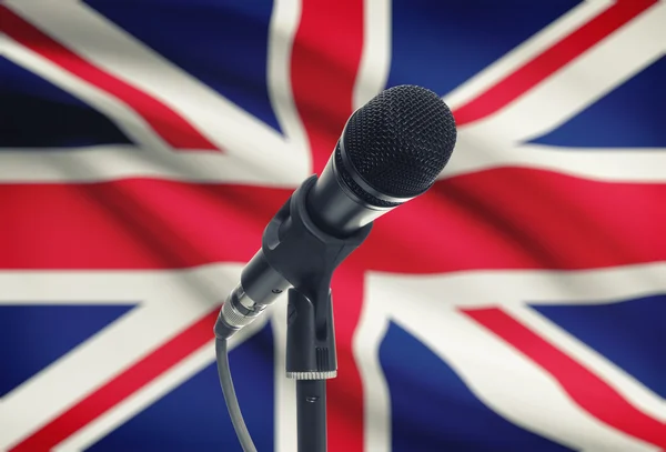 Microphone on stand with national flag on background - United Kingdom — Stock Photo, Image