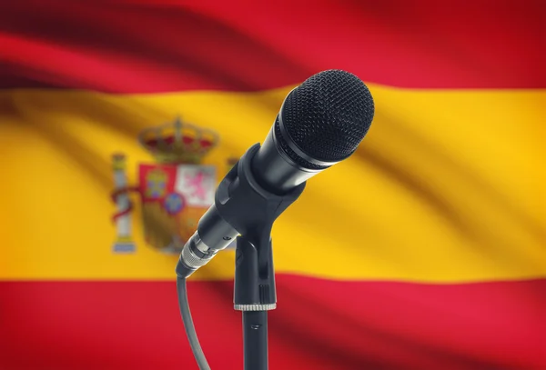 Microphone on stand with national flag on background - Spain — Stock Photo, Image