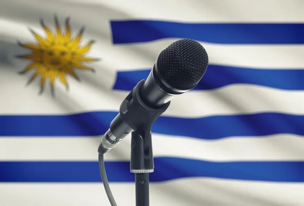Microphone on stand with national flag on background - Uruguay — Stock Photo, Image