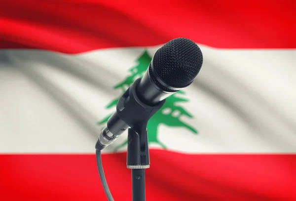 Microphone on stand with national flag on background - Lebanon — Stock Photo, Image