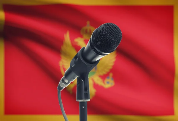 Microphone on stand with national flag on background - Montenegro — Stock Photo, Image