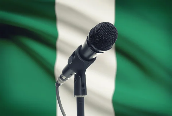 Microphone on stand with national flag on background - Nigeria — Stock Photo, Image