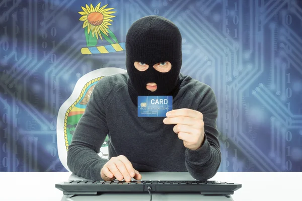 Hacker holding credit card and USA state flag on background - Kansas — Stock Photo, Image