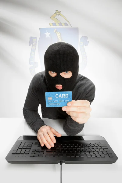 Hacker holding credit card with US state flag on background - Massachusetts — Stok fotoğraf