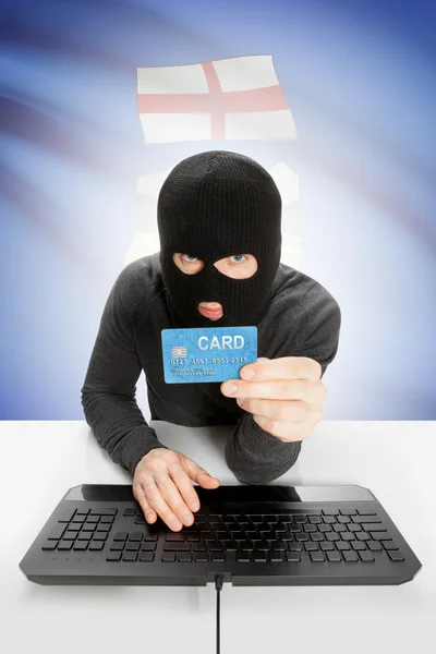 Hacker with credit card in hand and Canadian province flag on background - Alberta — Stock fotografie