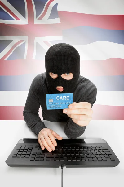 Hacker holding credit card with US state flag on background - Hawaii —  Fotos de Stock