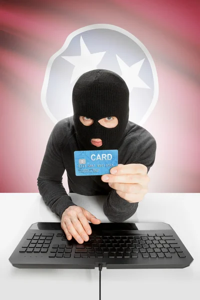 Hacker holding credit card with US state flag on background - Tennessee — Foto Stock