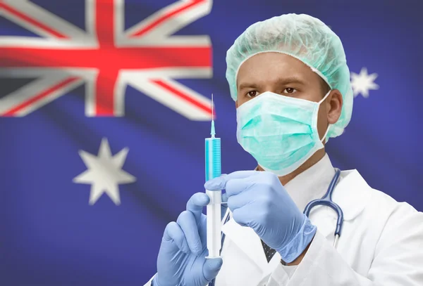 Läkare med spruta i händer och flagga på bakgrunden serien - Australien — Stockfoto