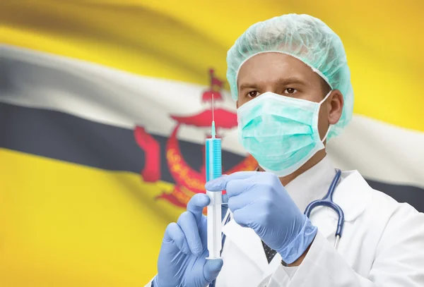 Médico con jeringa en las manos y la bandera en la serie de fondo - Brunei —  Fotos de Stock