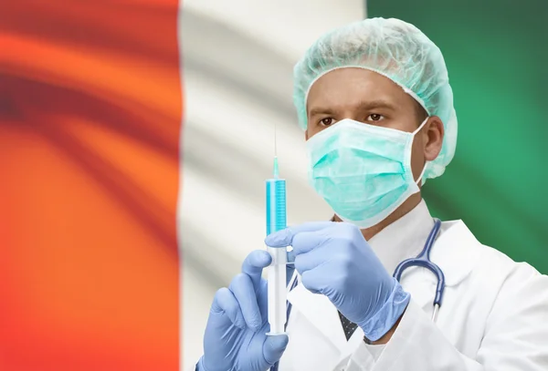 Doctor with syringe in hands and flag on background series - Ivory Coast — Stock Photo, Image