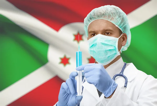 Médecin avec une seringue dans les mains et le drapeau sur la série de fond - Burundi — Photo