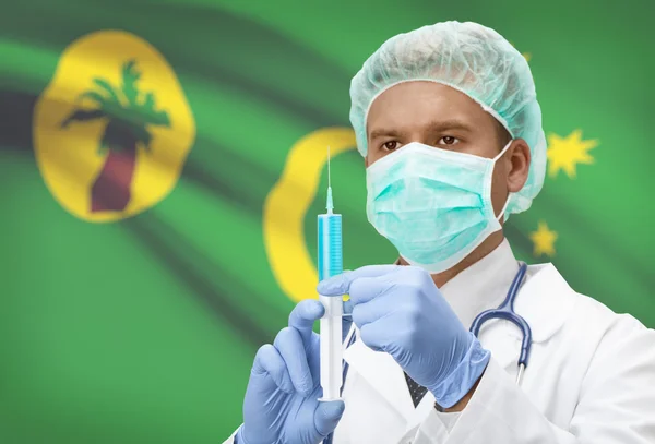 Doktor s injekční stříkačkou v ruce a vlajku na pozadí řady - kokosové (Keeling) ostrovy — Stock fotografie