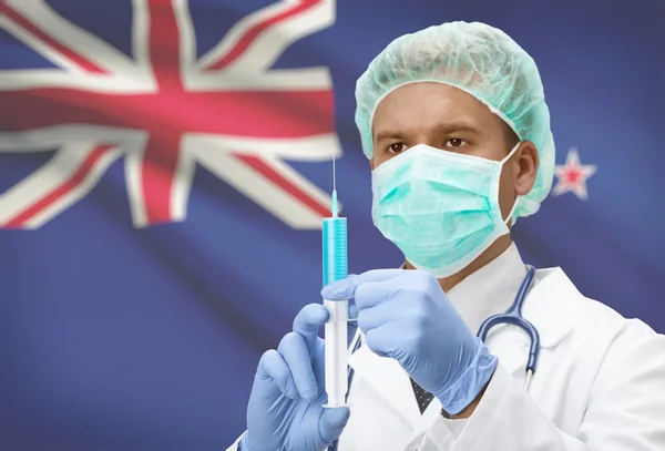 Médecin avec une seringue dans les mains et le drapeau sur la série de fond - Nouvelle Zélande — Photo