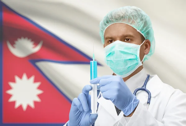 Medico con la siringa nelle mani e bandiera sulla serie della priorità bassa - Nepal — Foto Stock
