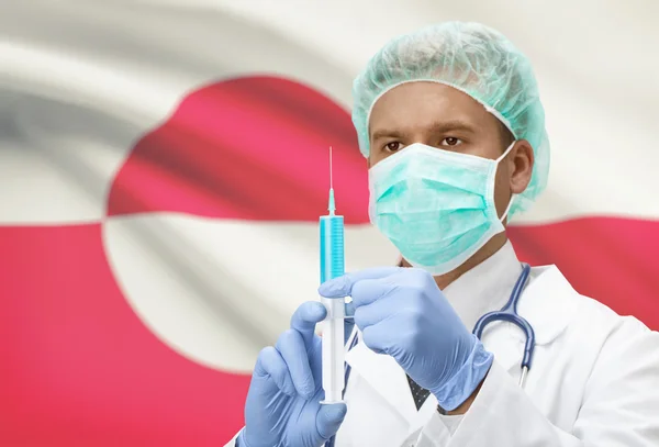 Médecin avec une seringue dans les mains et le drapeau sur la série de fond - Groenland — Photo